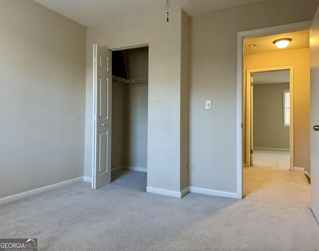 6900 Roswell Rd Unit 7N, Atlanta, GA 30328 - unfurnished bedroom with light carpet, a closet, and baseboards