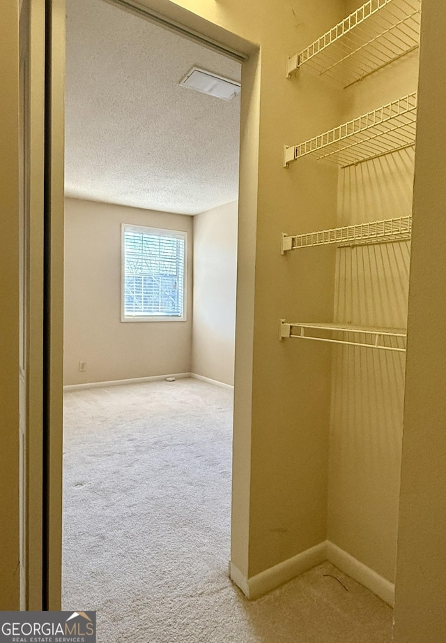 6900 Roswell Rd Unit 7N, Atlanta, GA 30328 - corridor featuring carpet floors, baseboards, and a textured ceiling