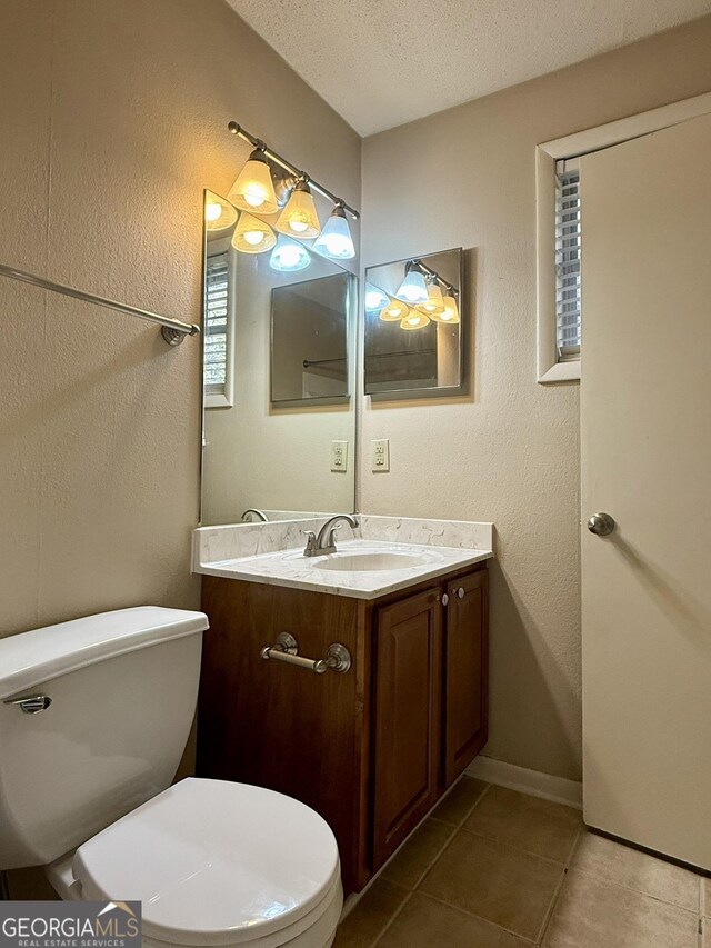 6900 Roswell Rd Unit 7N, Atlanta, GA 30328 - half bath featuring a textured wall, toilet, a textured ceiling, vanity, and tile patterned floors