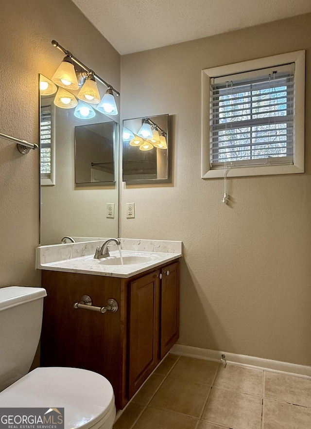 6900 Roswell Rd Unit 7N, Atlanta, GA 30328 - half bath with a textured ceiling, toilet, vanity, baseboards, and tile patterned floors