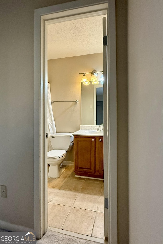 6900 Roswell Rd Unit 7N, Atlanta, GA 30328 - bathroom featuring toilet, tile patterned flooring, a textured ceiling, and vanity