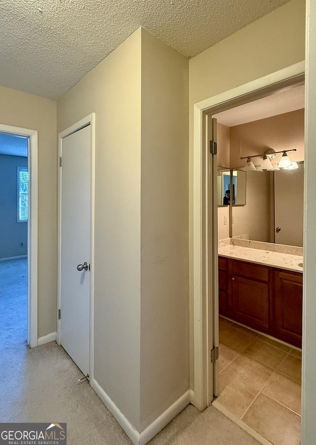 6900 Roswell Rd Unit 7N, Atlanta, GA 30328 - hallway with a textured ceiling and baseboards