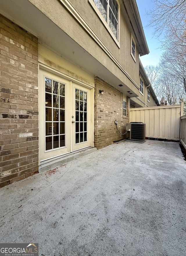 6900 Roswell Rd Unit 7N, Atlanta, GA 30328 - view of patio / terrace featuring french doors, fence, and central AC unit