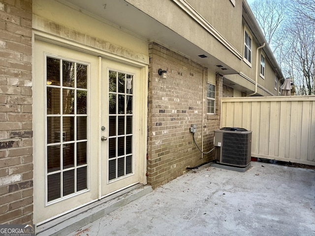 6900 Roswell Rd Unit 7N, Atlanta, GA 30328 - exterior space featuring french doors, brick siding, a patio area, fence, and cooling unit