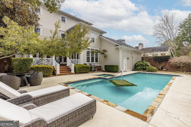 view of swimming pool with a fenced in pool, a patio area, fence, and an in ground hot tub