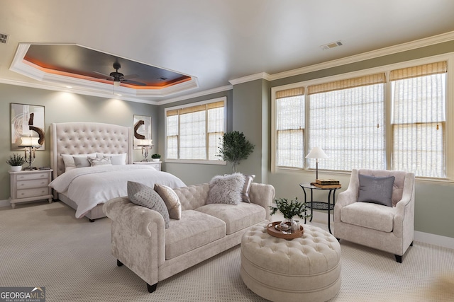 bedroom featuring crown molding, visible vents, a tray ceiling, and carpet flooring