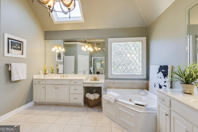 bathroom featuring vaulted ceiling with skylight, tile patterned flooring, two vanities, baseboards, and a bath