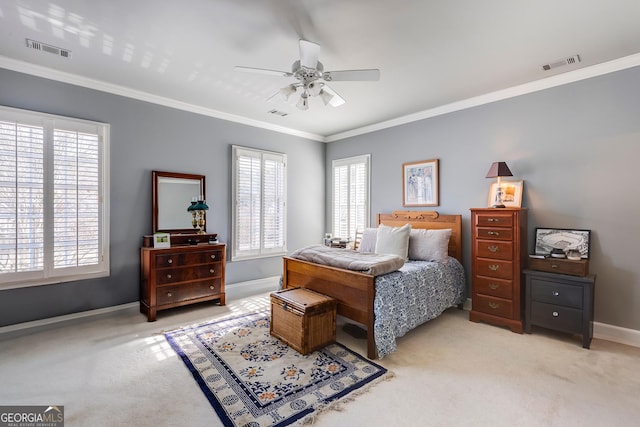 bedroom with light carpet, baseboards, visible vents, and crown molding