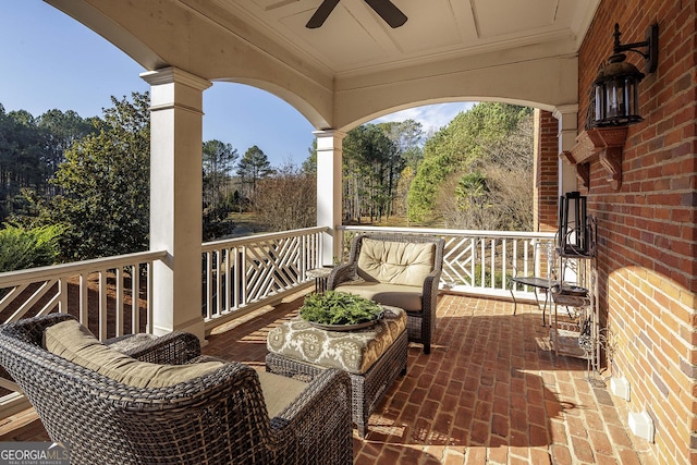 exterior space with covered porch, outdoor lounge area, and ceiling fan