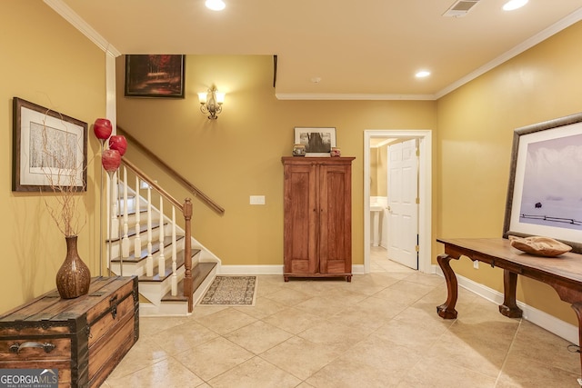 foyer entrance featuring baseboards, stairs, visible vents, and crown molding