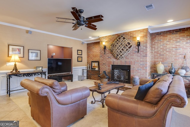 living area with a wainscoted wall, visible vents, ornamental molding, and a decorative wall