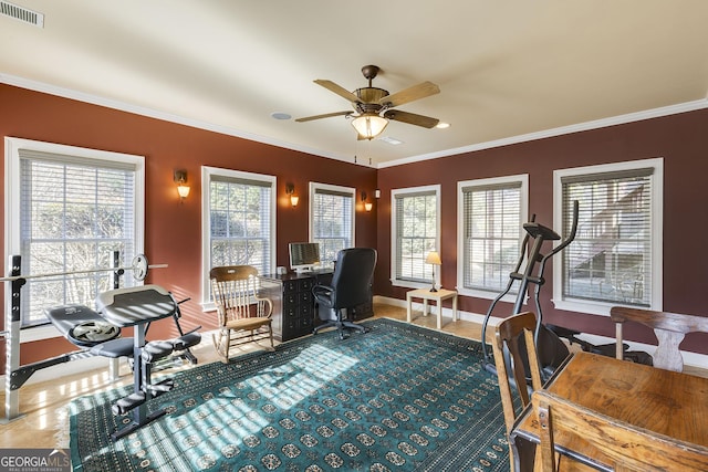 office space with ceiling fan, visible vents, baseboards, and ornamental molding