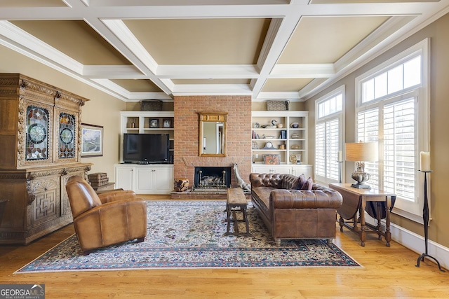 living room with crown molding, a brick fireplace, wood finished floors, coffered ceiling, and beamed ceiling