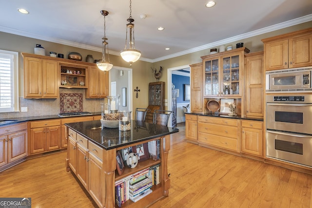 kitchen with appliances with stainless steel finishes, decorative light fixtures, a kitchen island, and open shelves