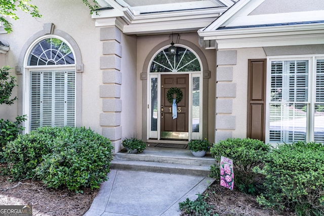 property entrance with stucco siding
