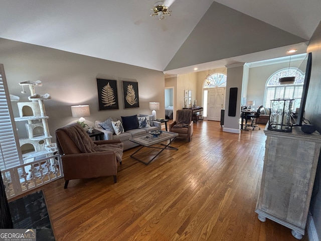 living room with high vaulted ceiling, wood finished floors, and baseboards