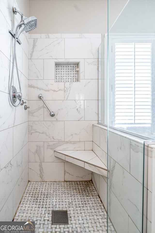 full bath with visible vents and a tile shower