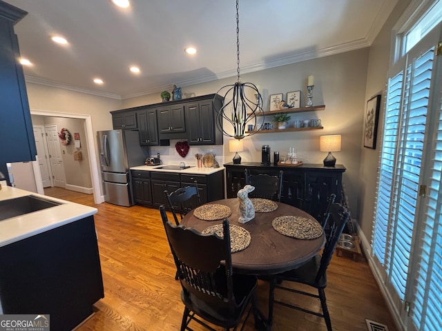 dining area with recessed lighting, visible vents, crown molding, and light wood finished floors