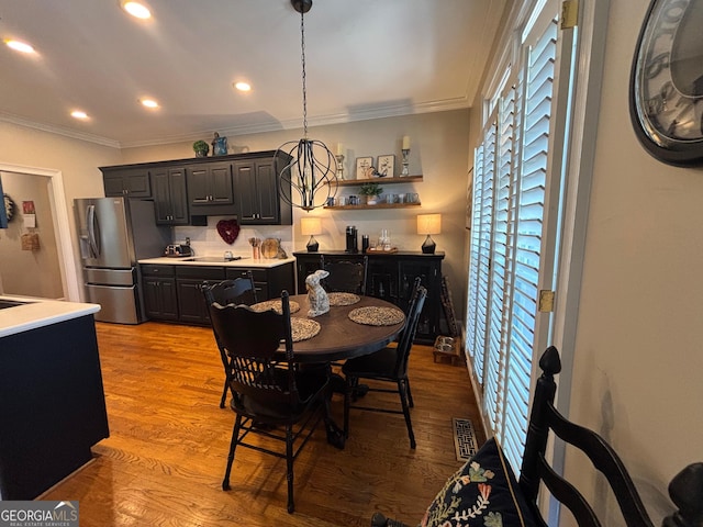 dining room with recessed lighting, light wood-type flooring, visible vents, and crown molding