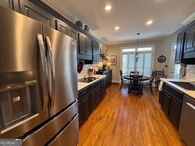 kitchen with dishwashing machine, ornamental molding, light countertops, and stainless steel fridge with ice dispenser