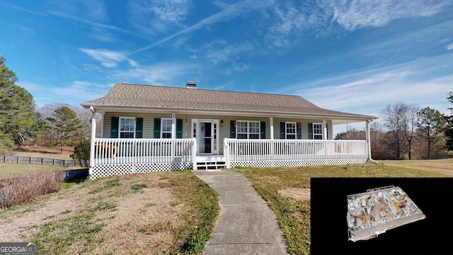 ranch-style home with covered porch and a front lawn