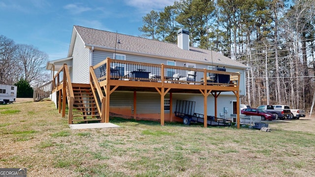 back of property featuring a chimney, a yard, stairway, and a wooden deck