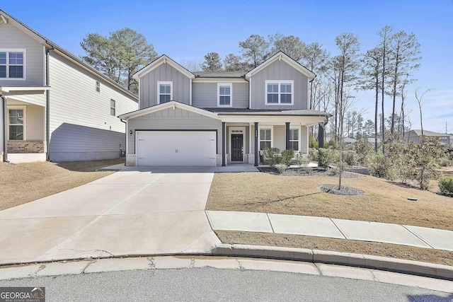 view of front facade with covered porch, a front yard, and a garage