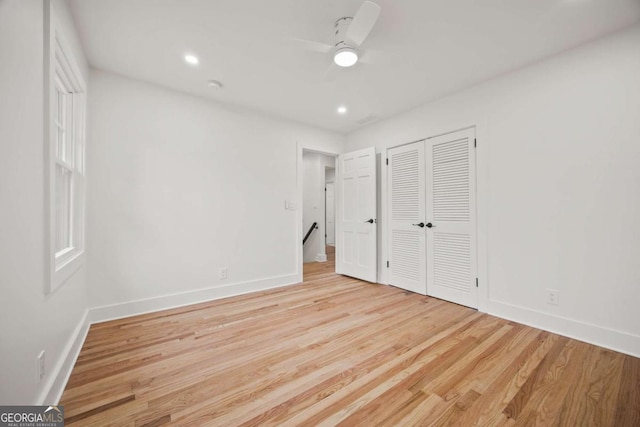 unfurnished bedroom featuring light wood-type flooring, a closet, and ceiling fan