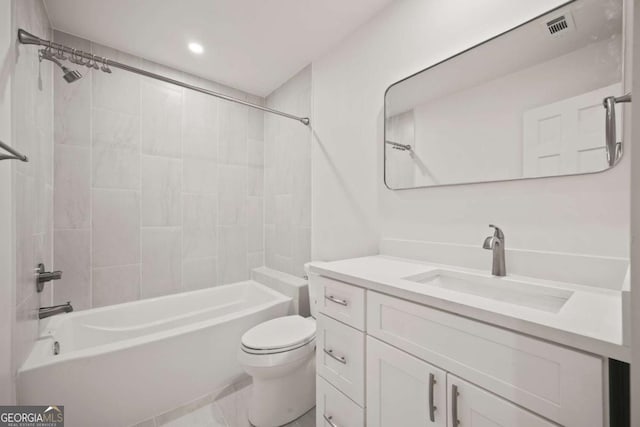 full bathroom with tiled shower / bath combo, toilet, and vanity