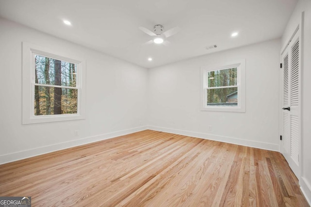 unfurnished bedroom with light hardwood / wood-style floors, a closet, and ceiling fan