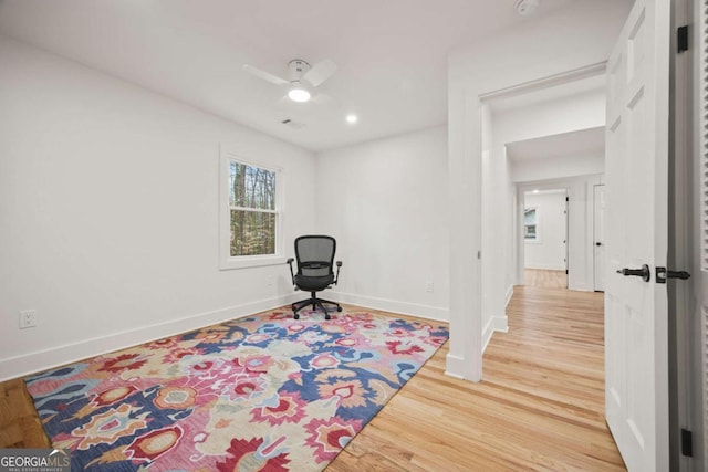 living area with ceiling fan and hardwood / wood-style floors