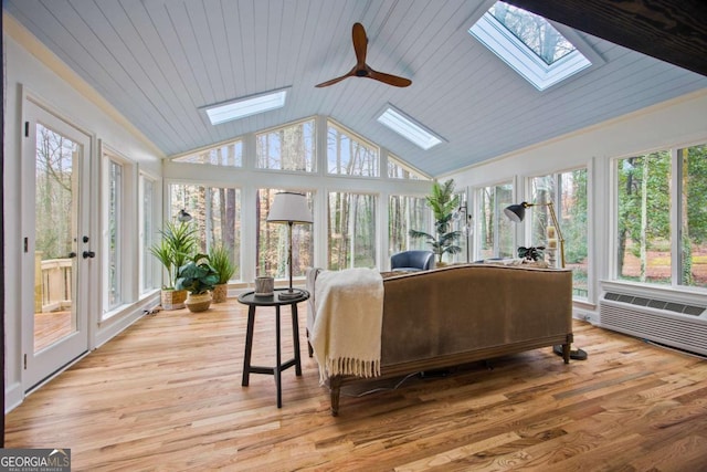 sunroom with lofted ceiling with skylight, wooden ceiling, and ceiling fan