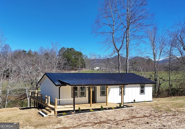 view of front of property with a wooden deck and a porch