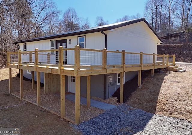 back of house with a wooden deck