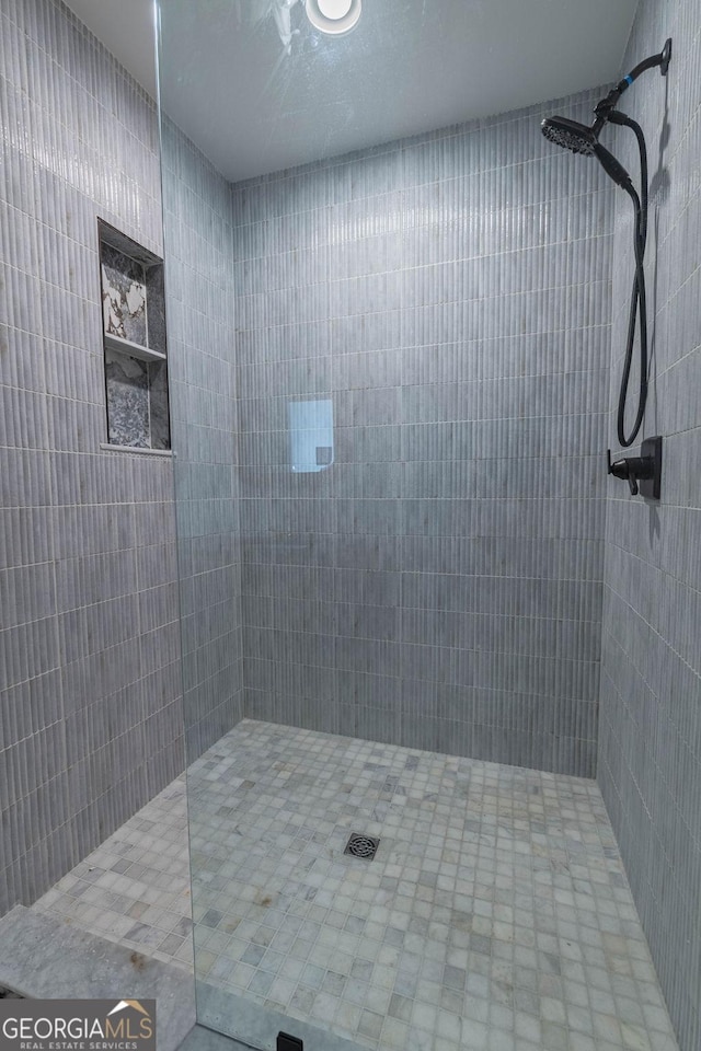 bathroom with a tile shower