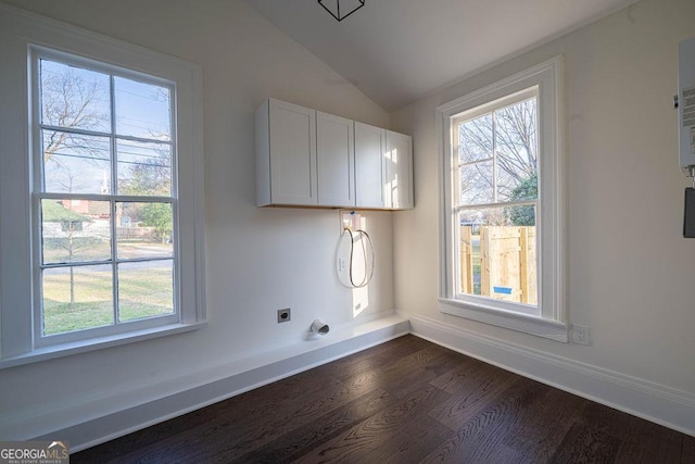 clothes washing area with dark wood-type flooring, hookup for an electric dryer, and cabinets