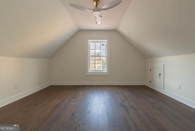 additional living space with lofted ceiling, dark hardwood / wood-style floors, and ceiling fan