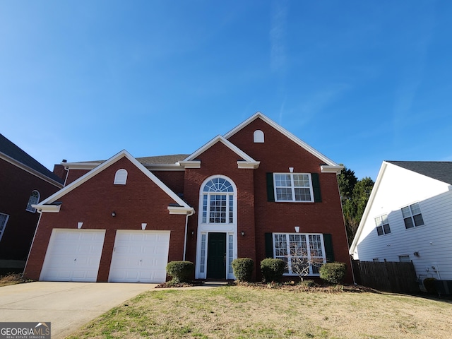 view of property with a front yard and a garage