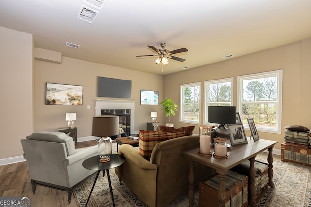 living room with hardwood / wood-style floors and ceiling fan