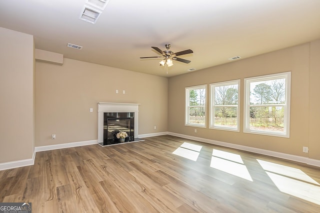 unfurnished living room with light hardwood / wood-style flooring and ceiling fan