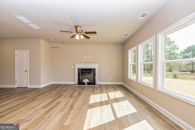 unfurnished living room featuring ceiling fan and light hardwood / wood-style flooring