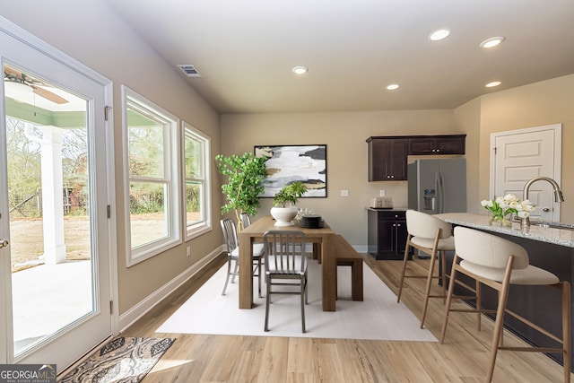 dining space featuring light hardwood / wood-style flooring and sink