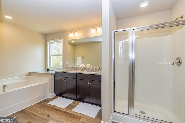 bathroom featuring vanity, shower with separate bathtub, and wood-type flooring