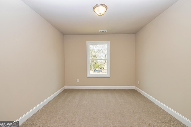 unfurnished room with light carpet