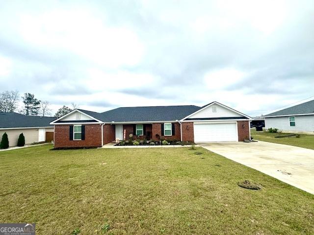 ranch-style home with a front yard and a garage