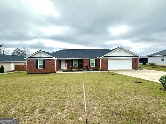 ranch-style home featuring a front lawn and a garage