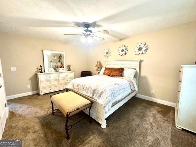 bedroom with ceiling fan and dark colored carpet