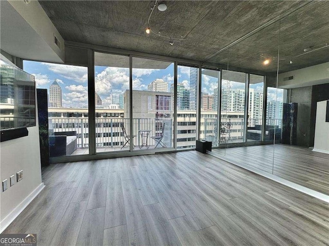 interior space with a wall of windows and wood-type flooring