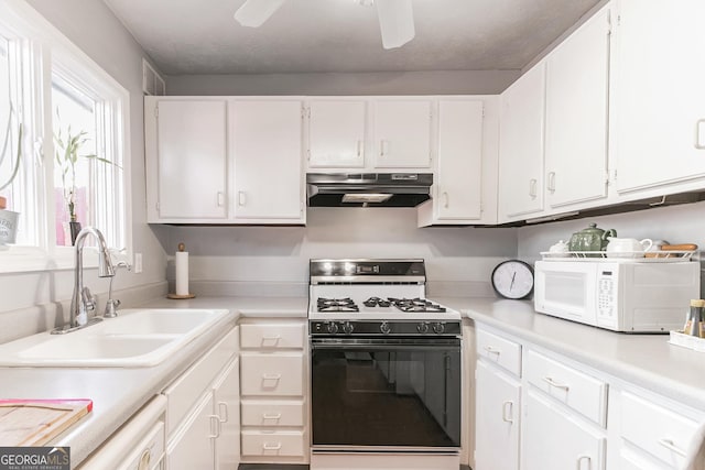 kitchen with sink, white cabinets, range with gas cooktop, and ceiling fan