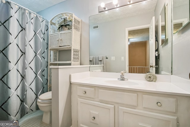 bathroom with curtained shower, vanity, and toilet